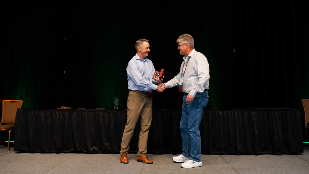 Ross Ambrose receiving recognition on stage